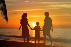 happy-family-two-kids-sunset-beach-tropical-56719950